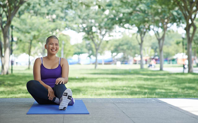 Woman doing yoga in a park.