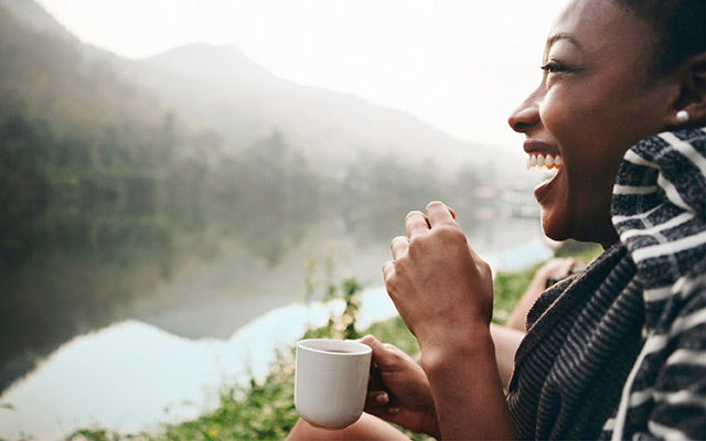 Woman drinking coffee in nature.