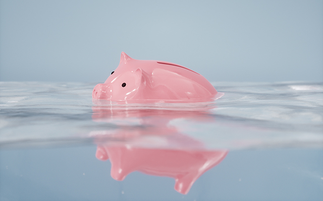 A piggy bank bobs in the water.