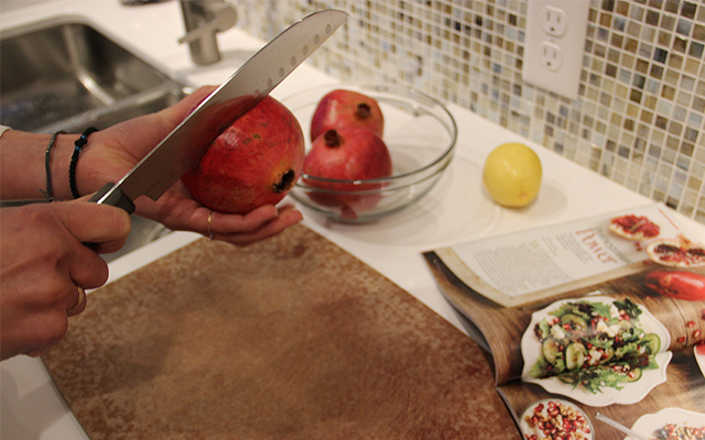 A knife cutting a pomegranate