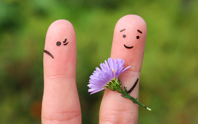 Two fingers are drawn as people — one who is angry and one who has flowers and is trying to apologize.