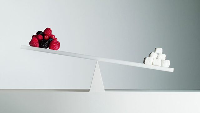 Scale of fruits and sugar cubes