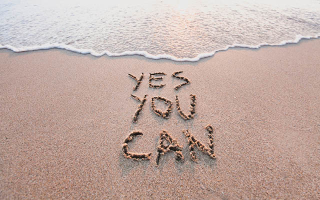 "yes you can" written in sand