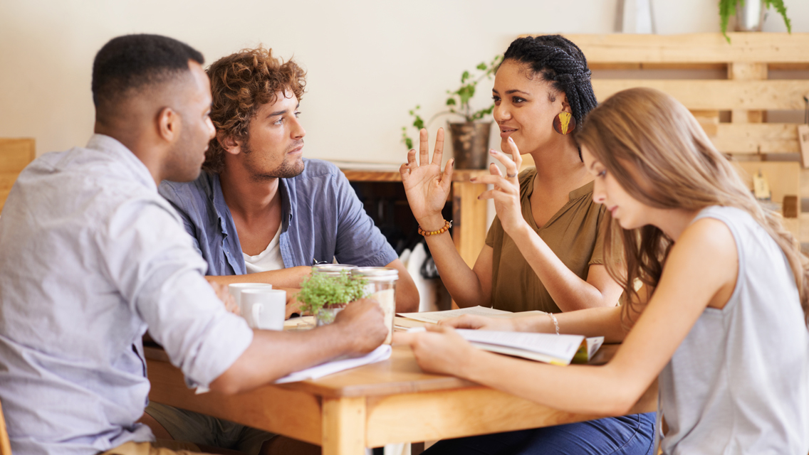 a group of friends sit and talk