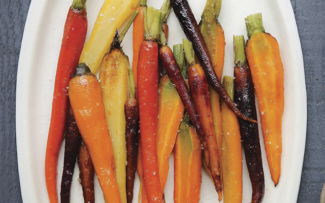 a plate of colorful cinnamon glazed carrots by the Detoxinista