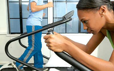A woman is intensely working out.