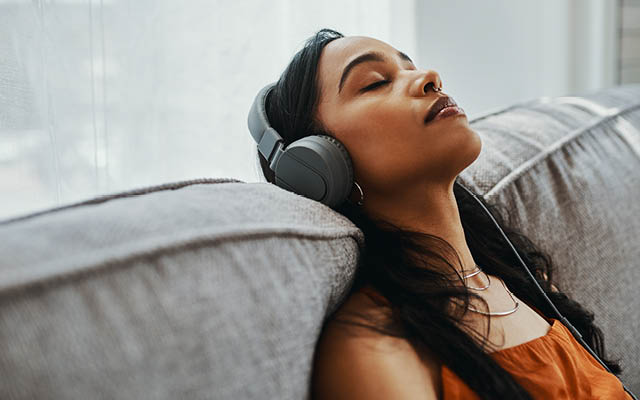 Woman listening to headphones and resting