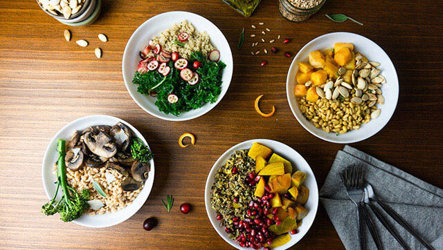 Four grain bowls are pictured.