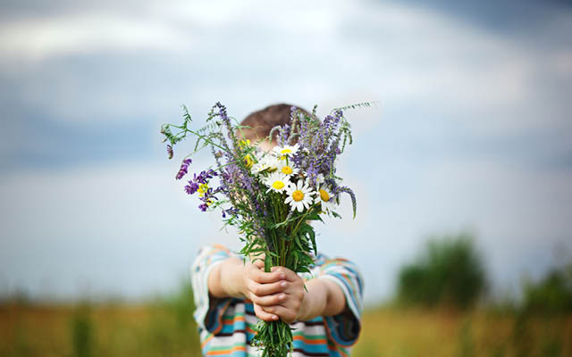 child giving flowers