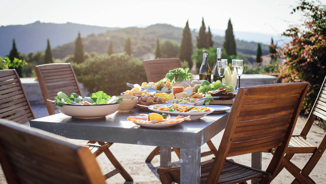 a table set outside on a patio in the Mediterranean