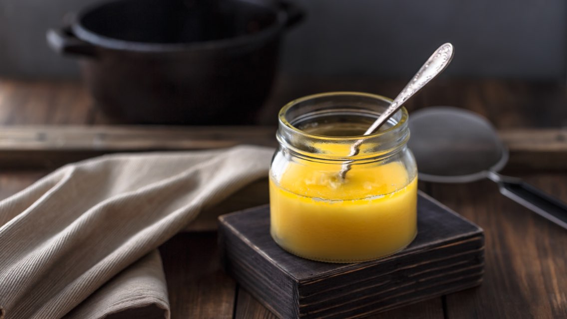 butter in a small jar with a spoon