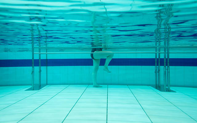 underwater image of legs marching in a pool