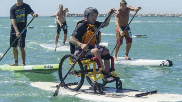 Charles Webb using an adapted paddle board
