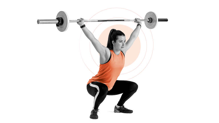 a woman performs an overhead squat
