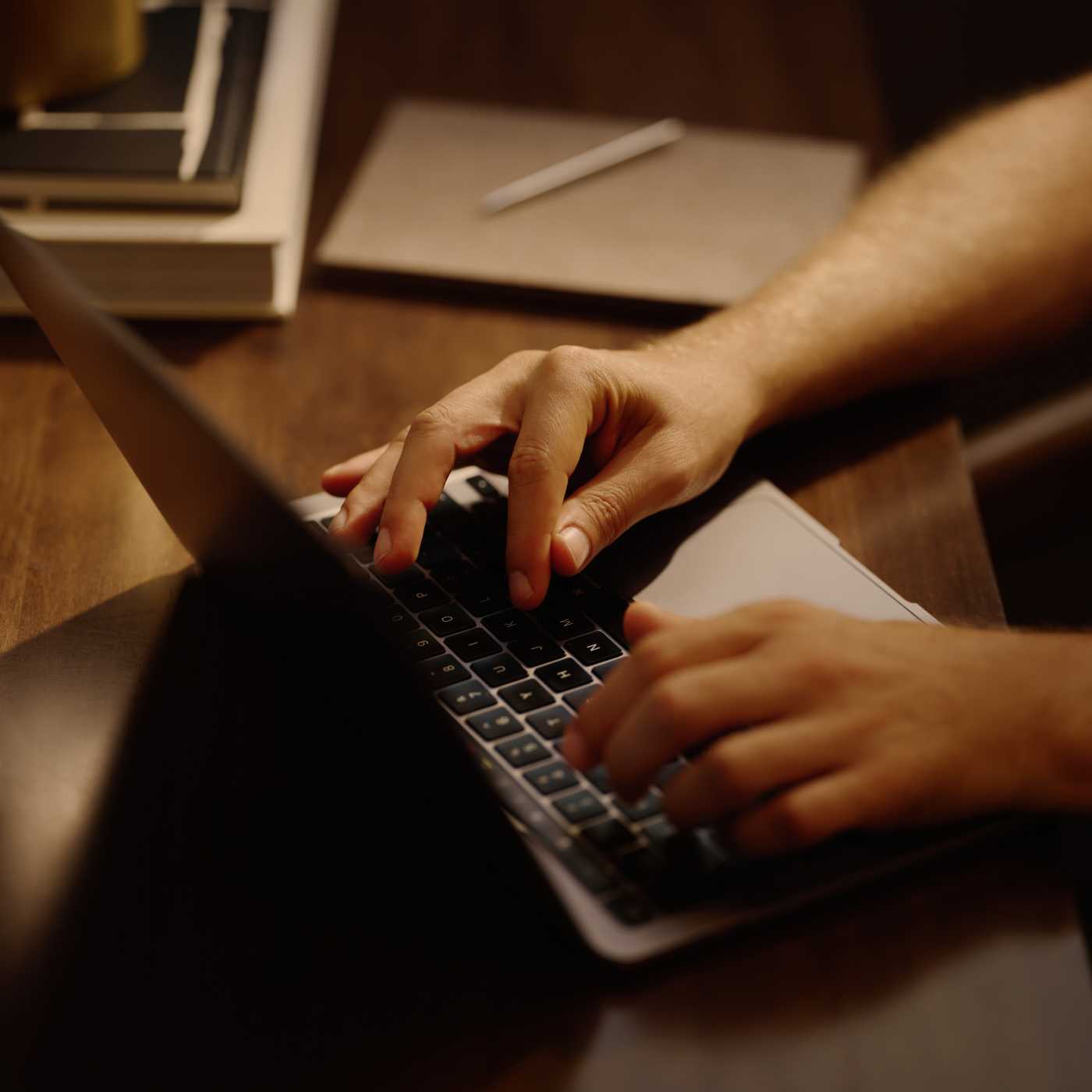 hands typing on a laptop