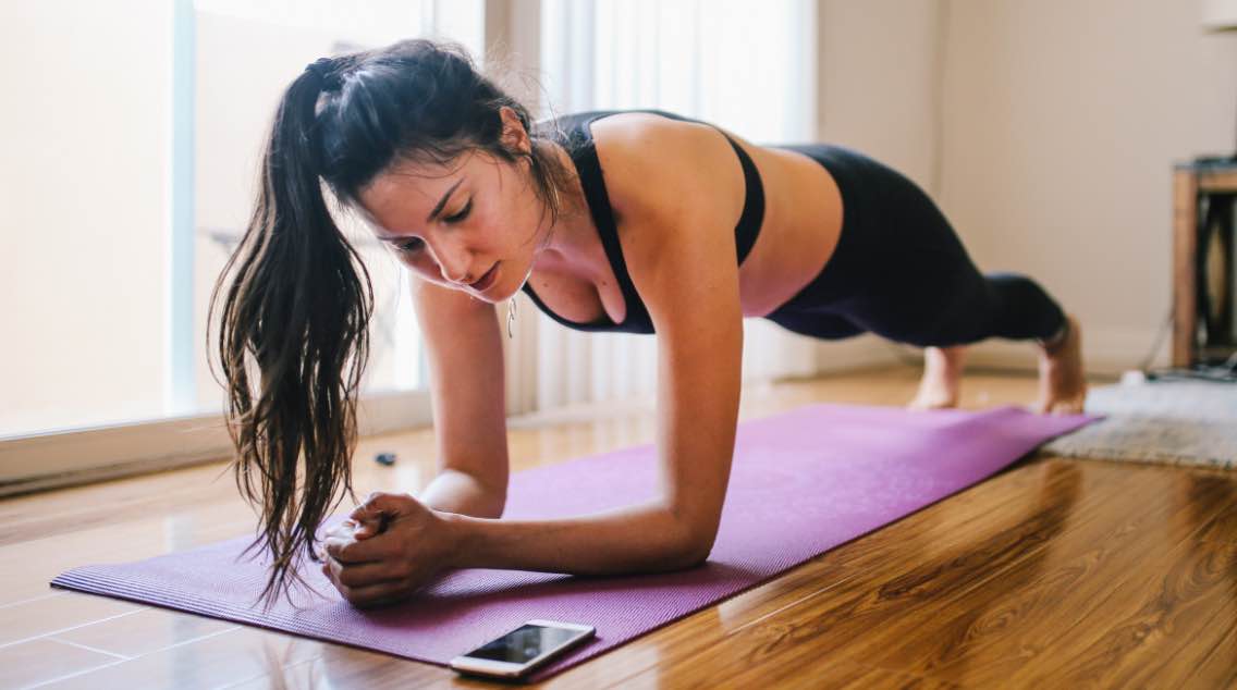 A woman doing a plank at home.