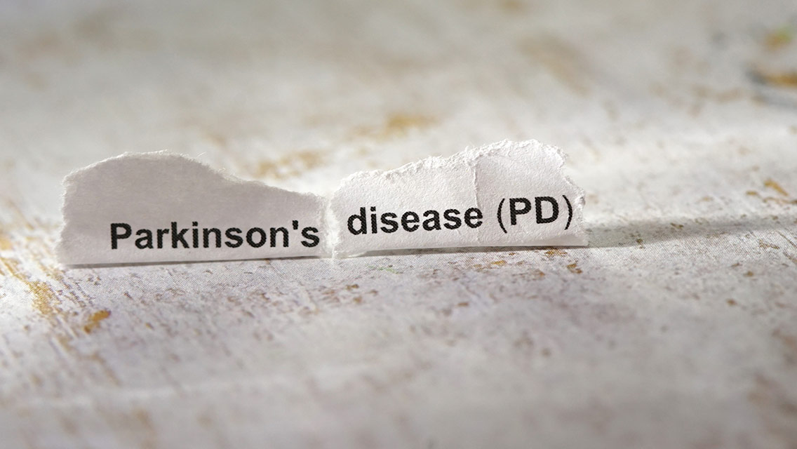 A ripped piece of paper that spells out Parkinson's disease