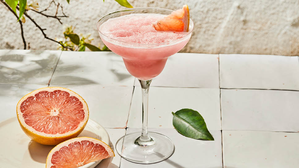 a glass of pink grapefruit margarita