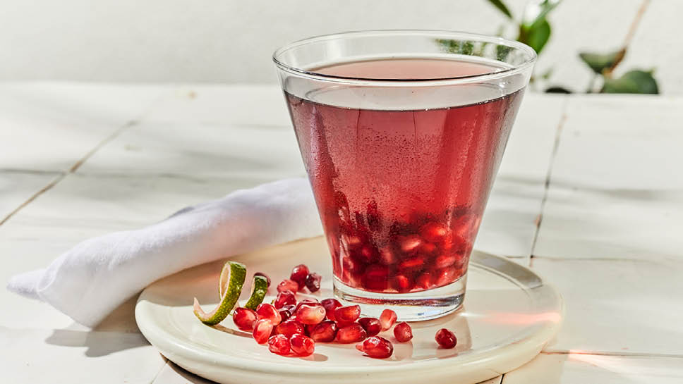 a glass of pomegranate limi tini