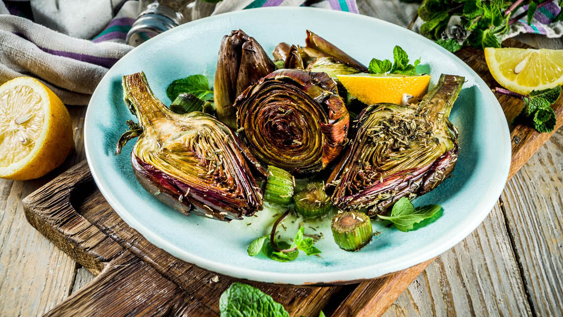 roasted artichokes with a wedge of lemon