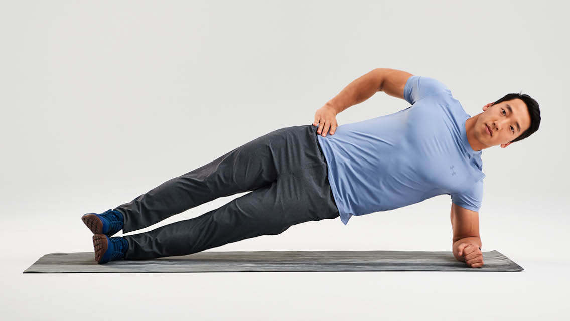 a man holds forearm side plank