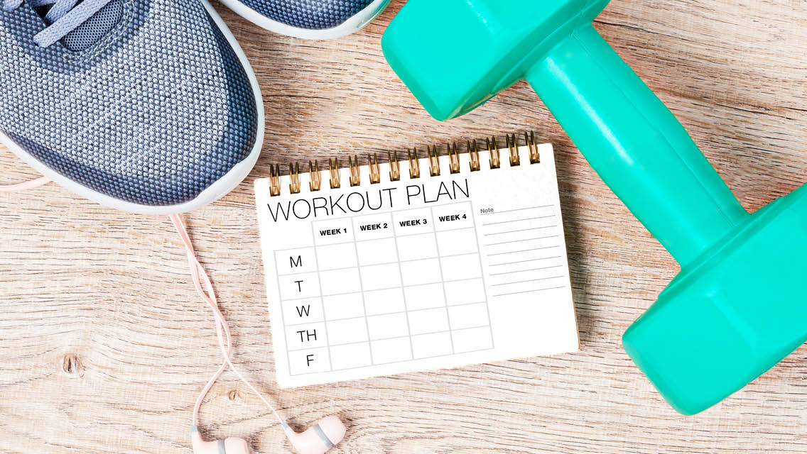 workout gear set alongside a workout plan journal