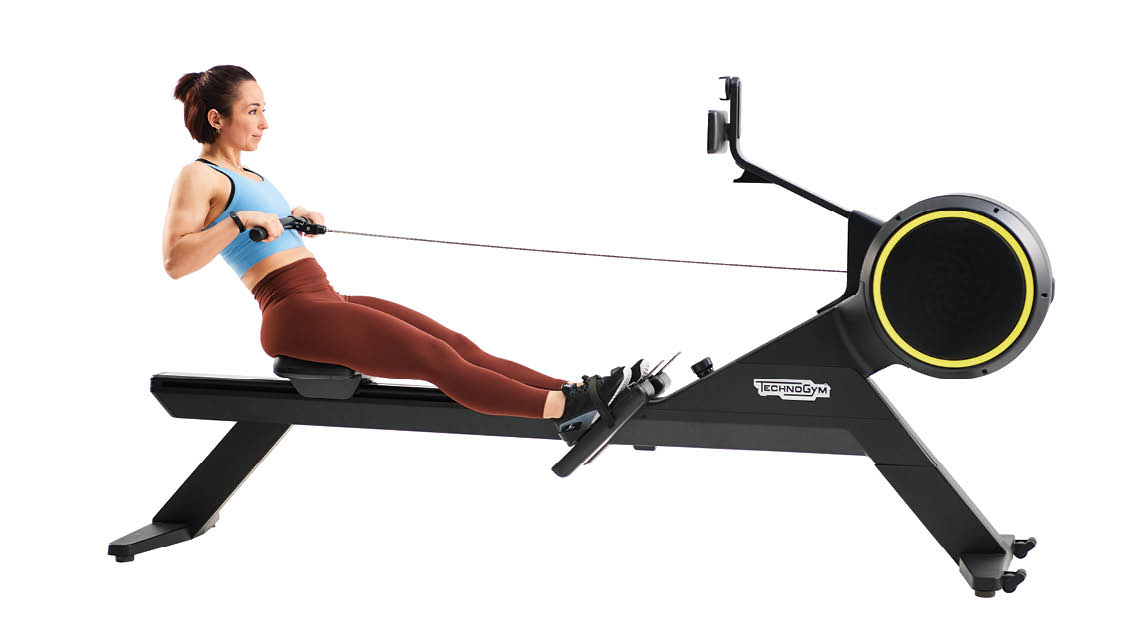 a woman uses a rowing machine