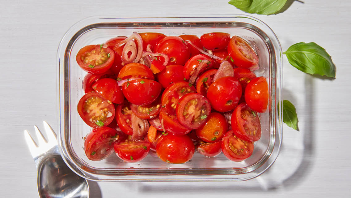 glass container filled with balsamic marinated tomatoes