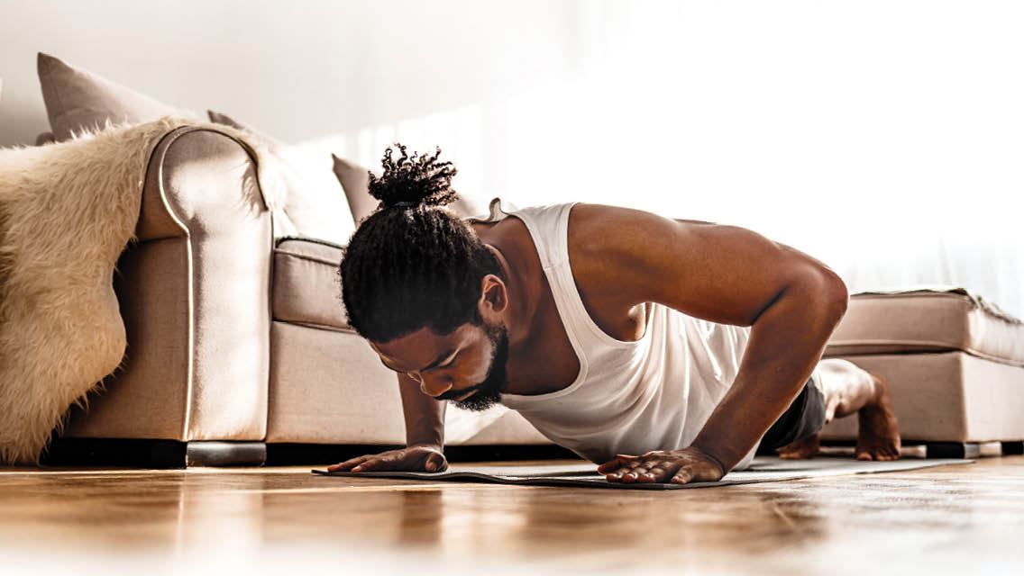 a man does a push up in his living room