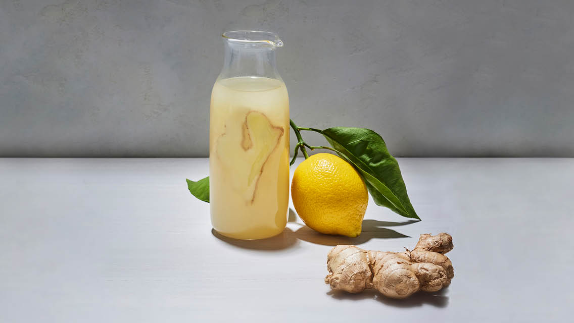 a carafe filled with Aviva Romm's ginger wellness drink