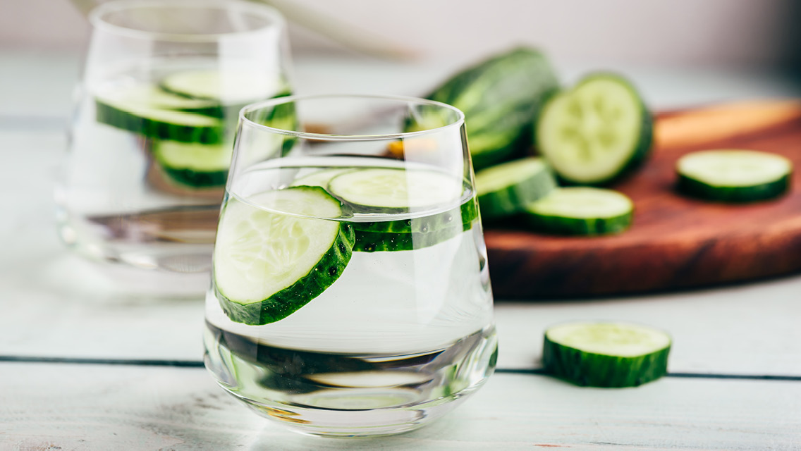 a glass of water with cucumbers