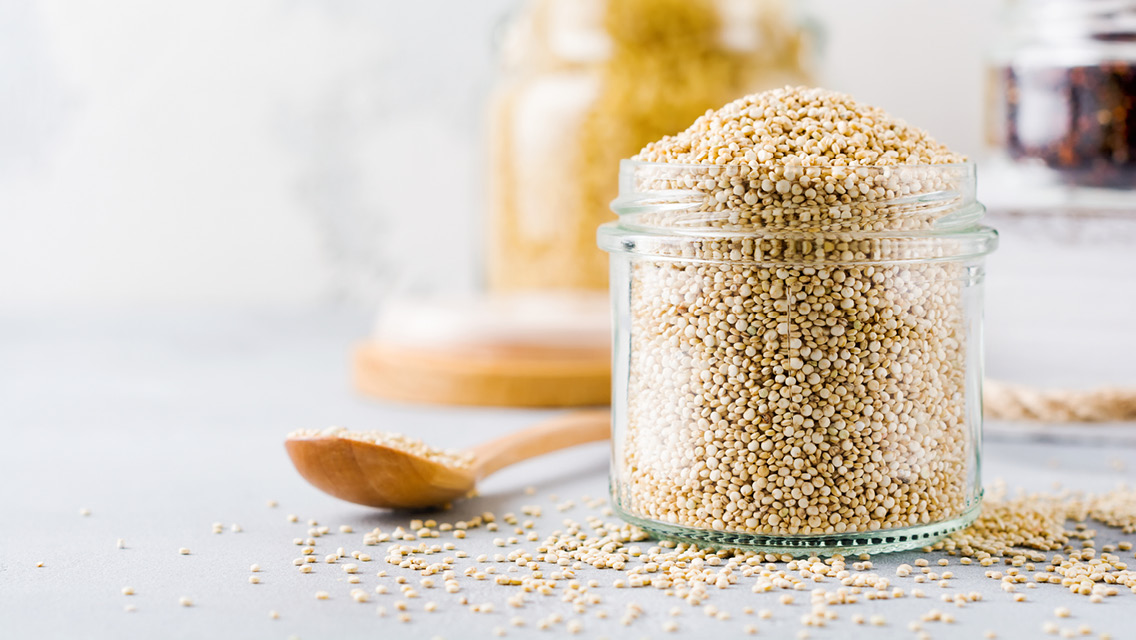a glass jar filled with uncooked quinoa