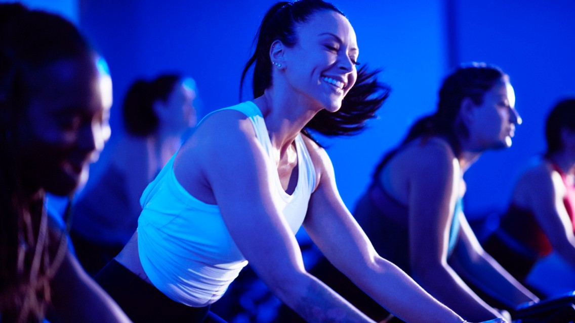 A group cycle class in a studio at Life Time.