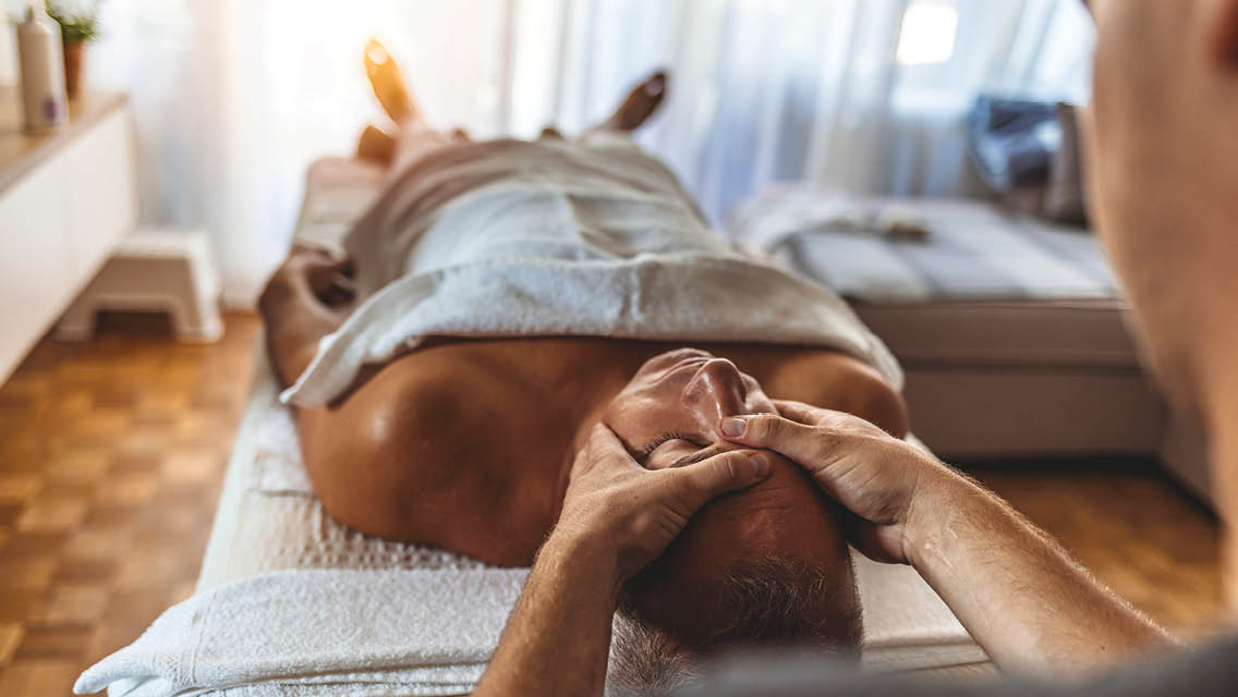 a person receives a head massage