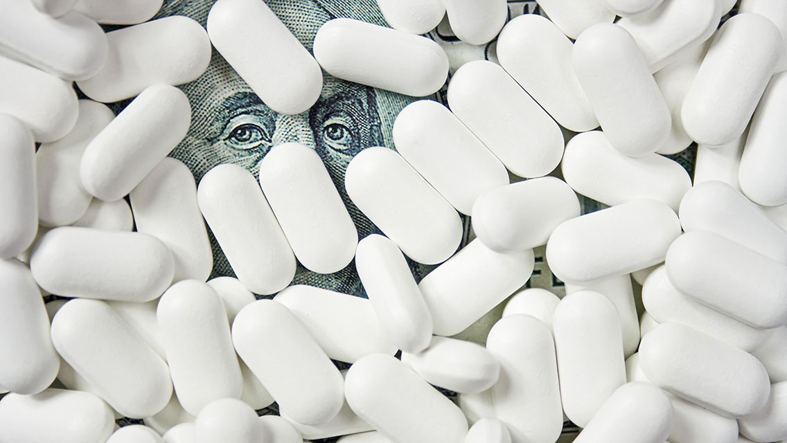 A 100-dollar bill covered in pills