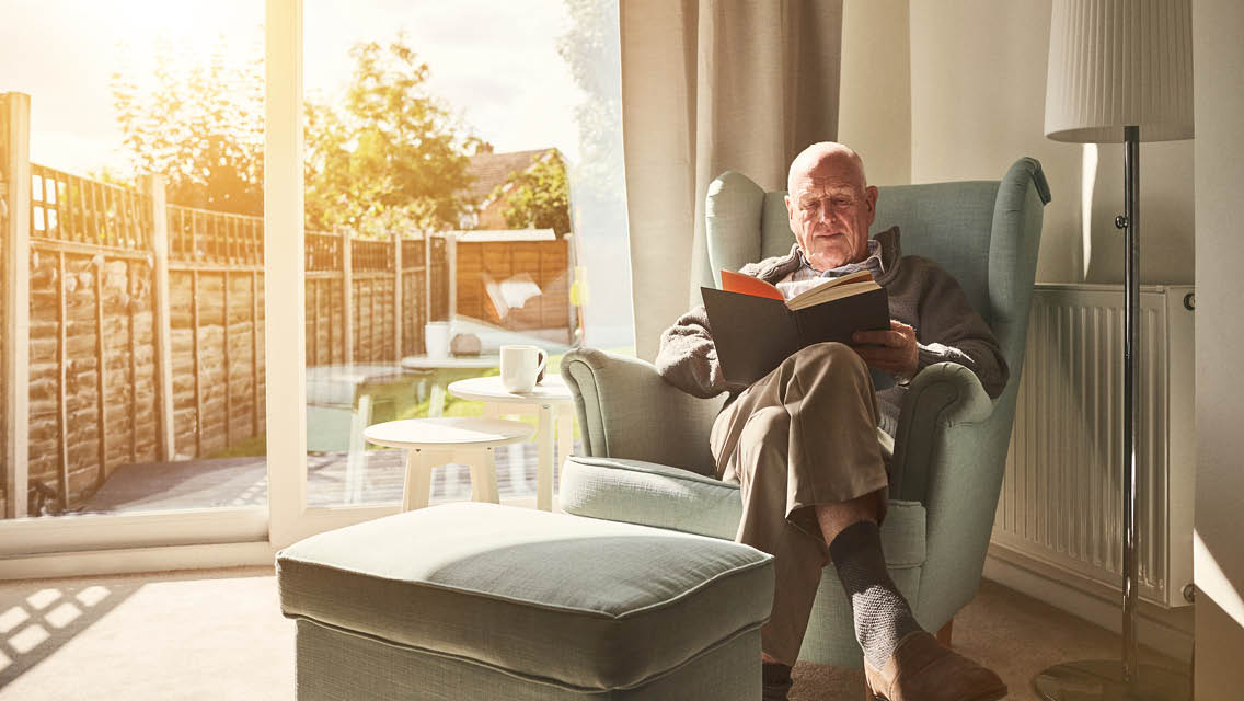 a senior citizens reads a book