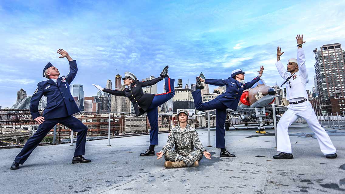 Various people in military uniform doing yoga