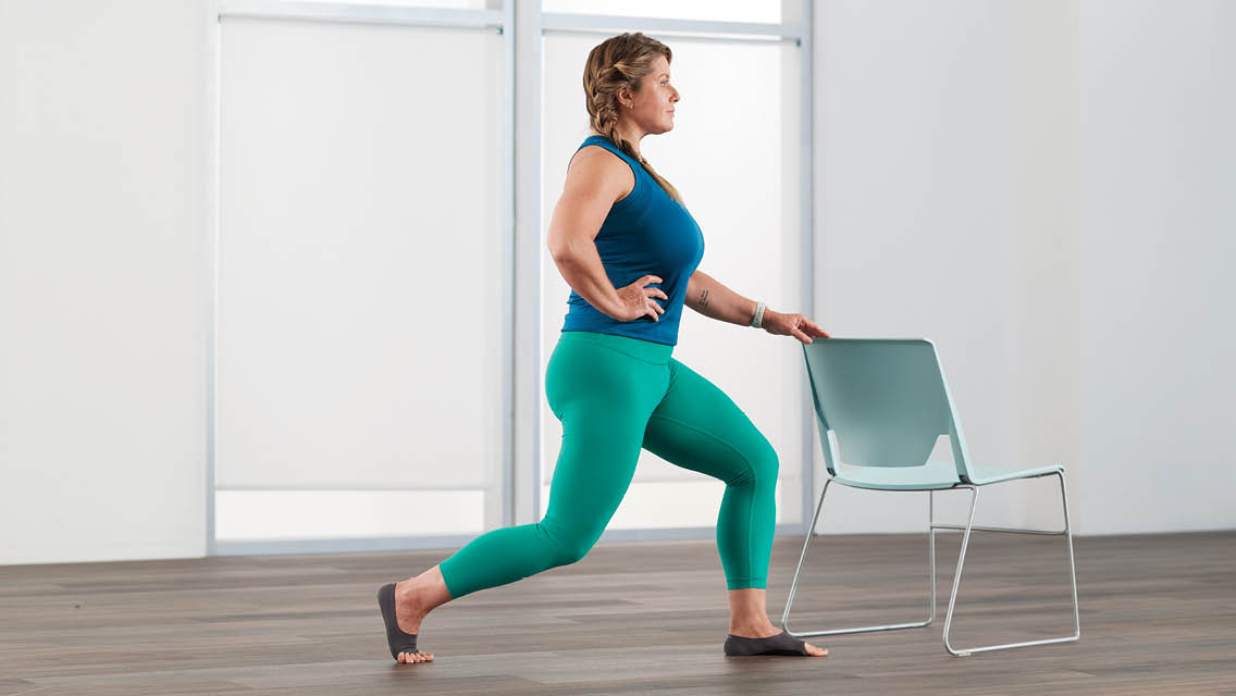 a woman holds a lunge position