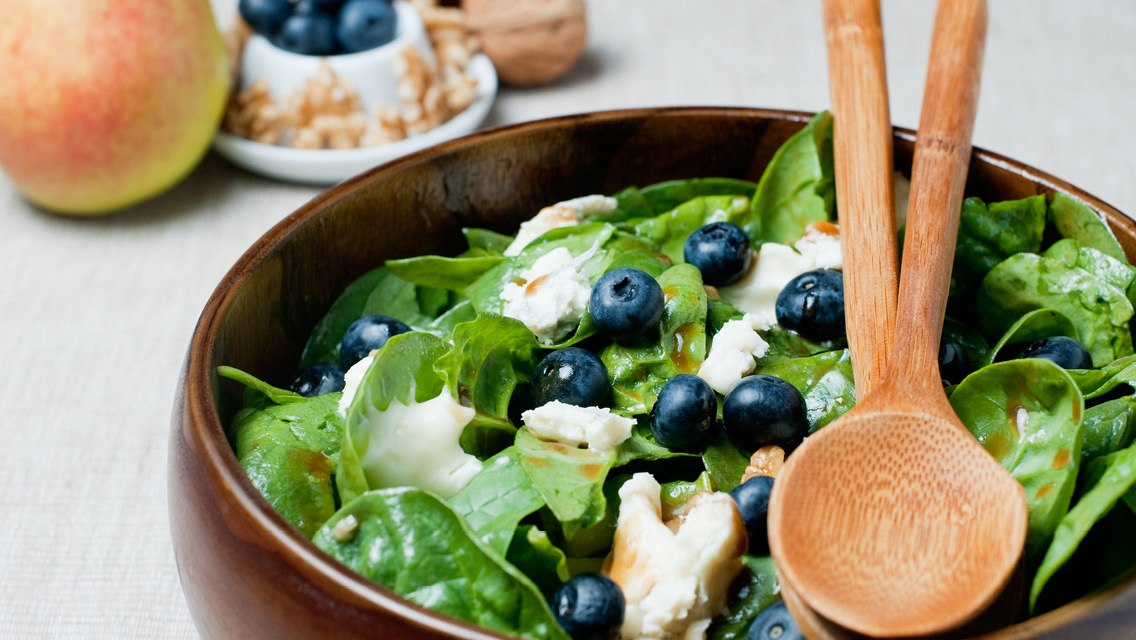 a green salad with blueberries
