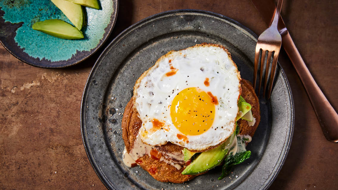 savory pancakes topped with an egg and avocado