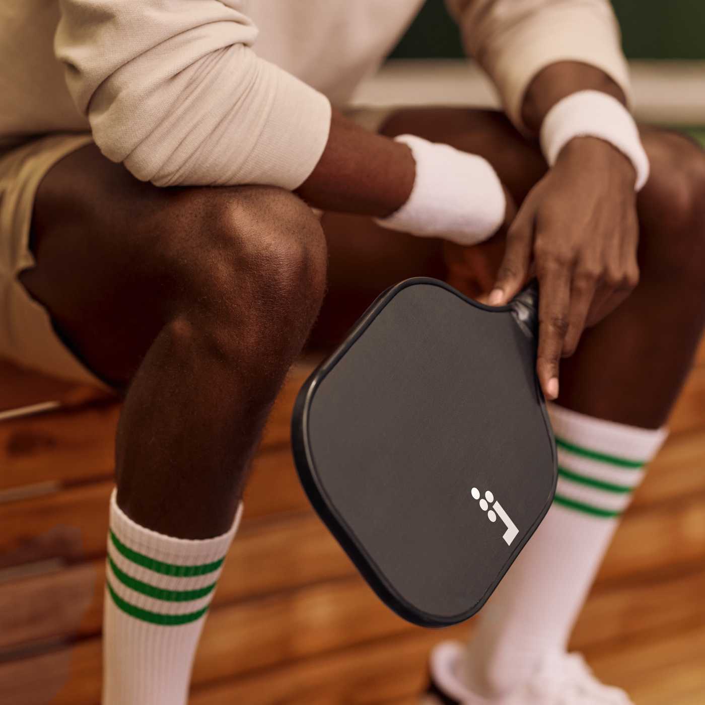 man holding pickleball paddle
