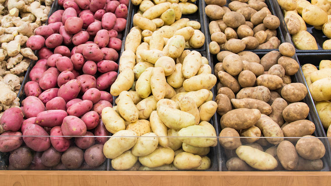 bins of a variety of potatoes