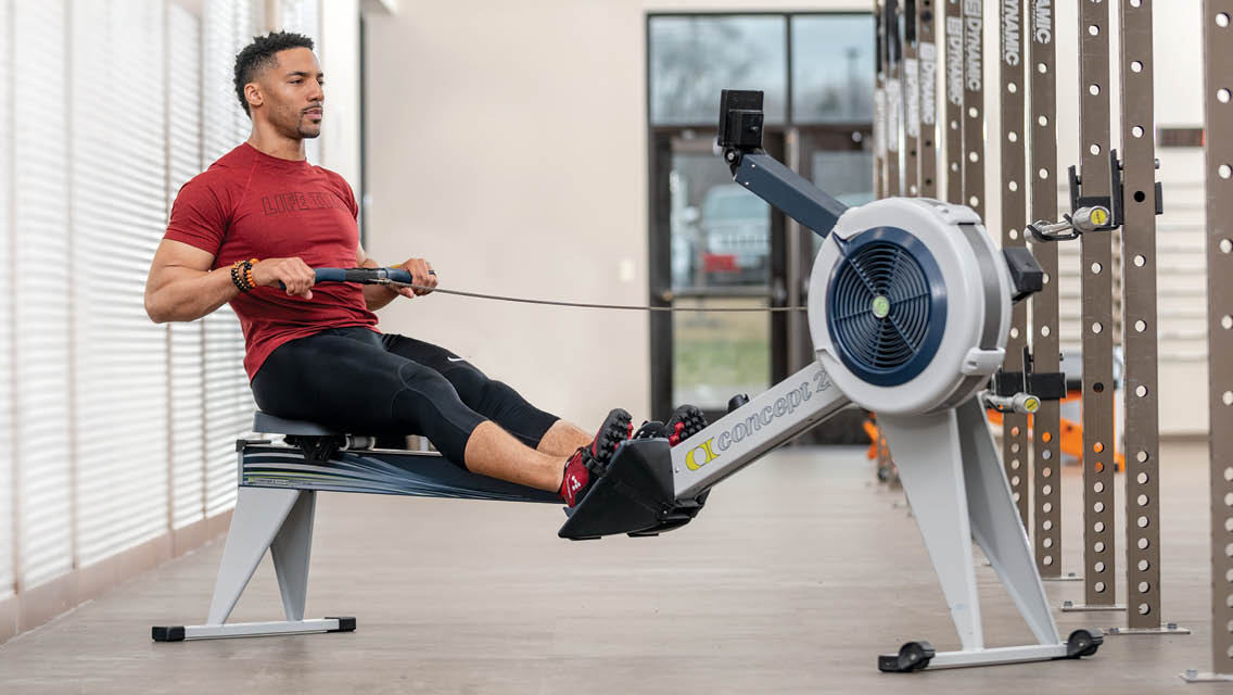 a man uses a rowing machine