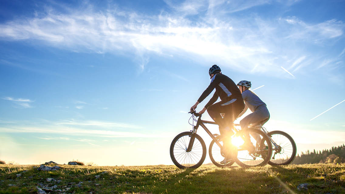 two cyclists on a dirt trail