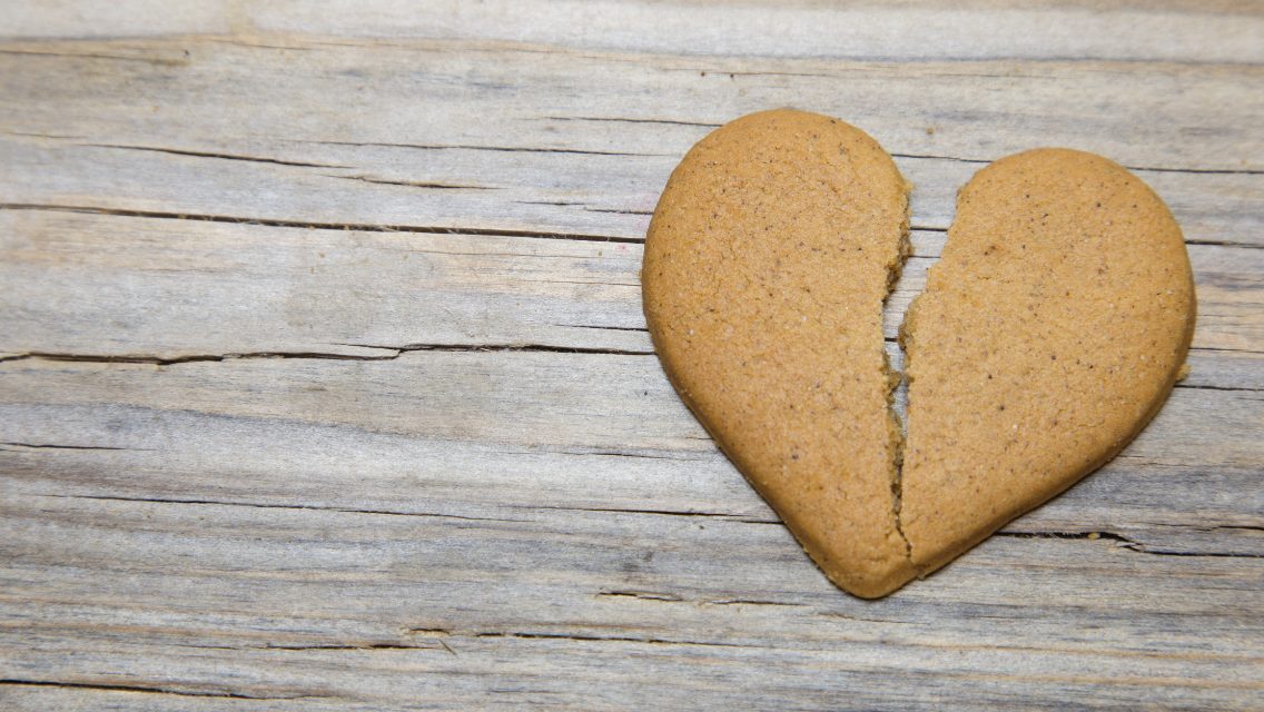 A cookie in the shape of a broken heart.