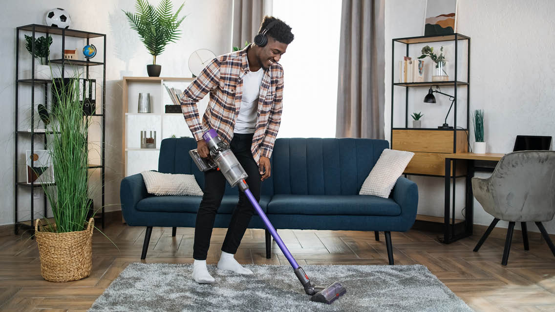 a man vacuums his living room