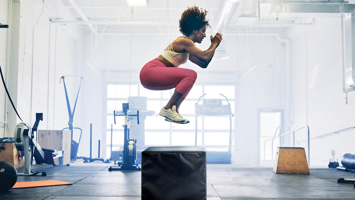 a woman jumps onto a platform