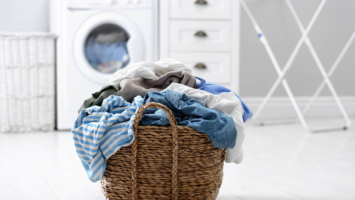 a basket of dirty laundry in a laundry room