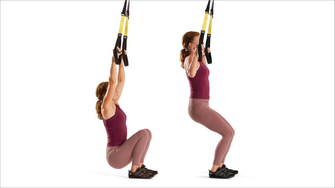 a woman performs the TRX pullup