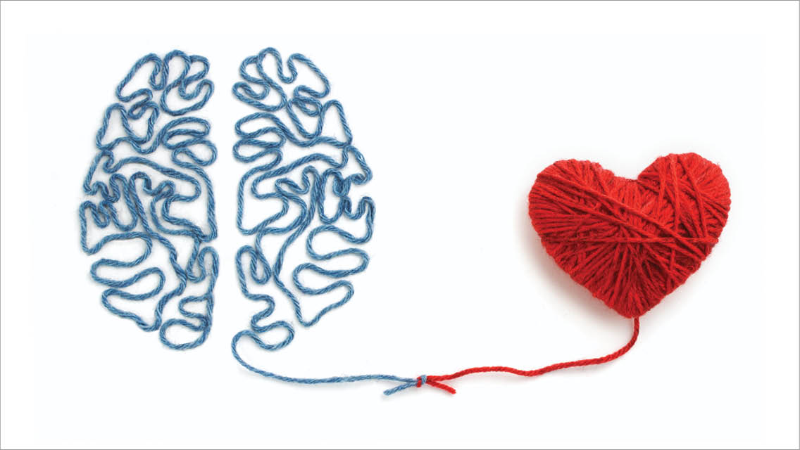 yarn makes an outline of brain which is attached to a heart made of yarn